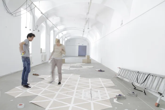 Alin Cirstea and Anna Frida Jónsdóttir in the making off of the Cloud structure. Model 1:1, wood plates and gaffer tape. Photo © Sabina Teichert
