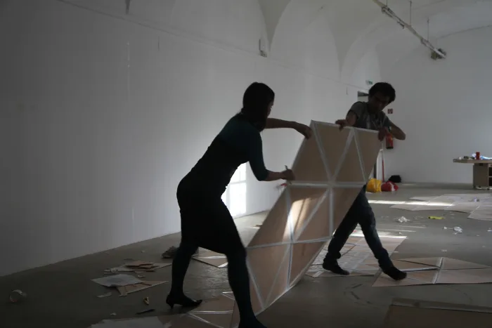Alin Cirstea and Irina Busurina in the making off of the Cloud structure. Model 1:1, wood plates and gaffer tape. Photo © Sabina Teichert
